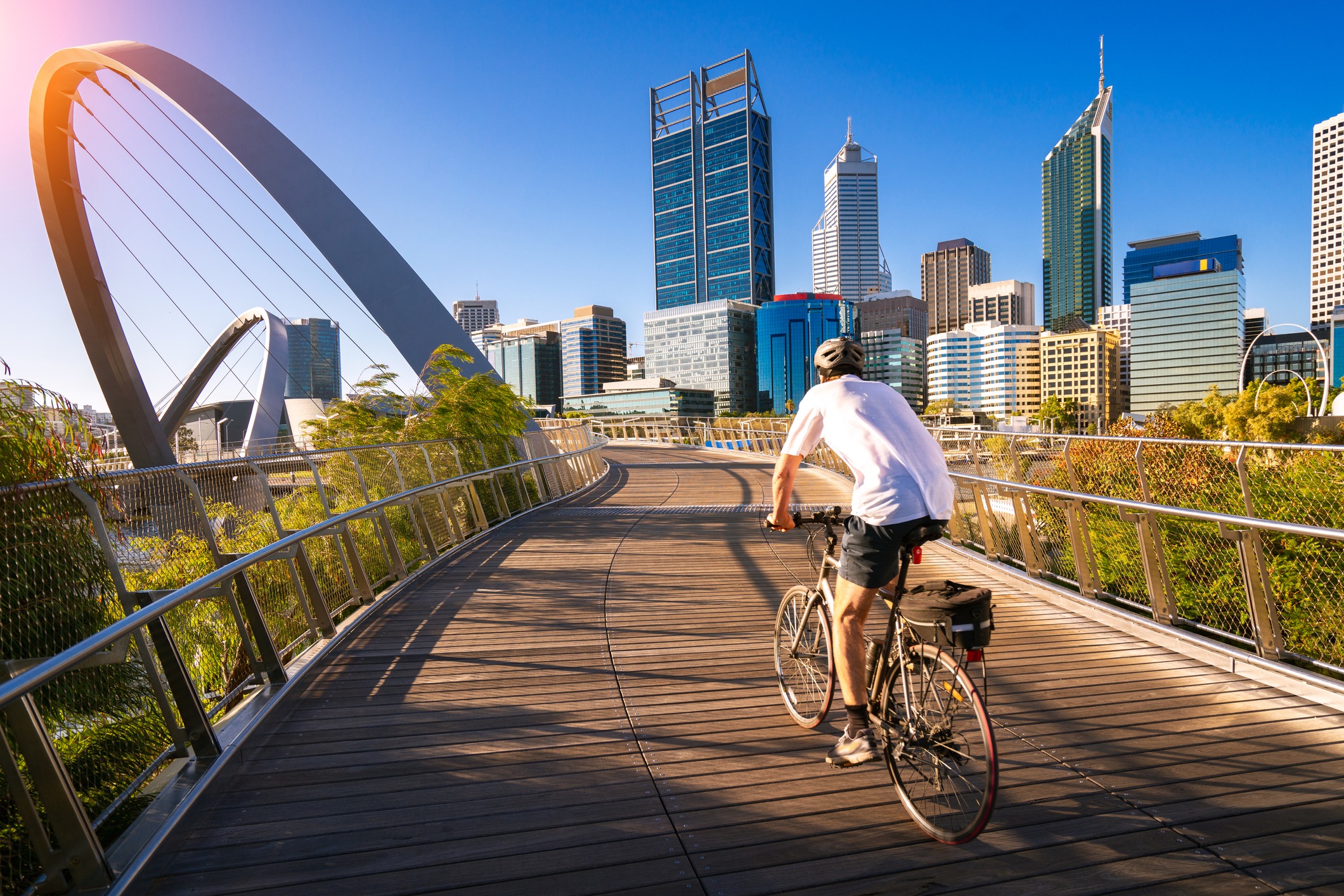 a-man-cycling-on-an-elizabeth-bridge-in-perth-city